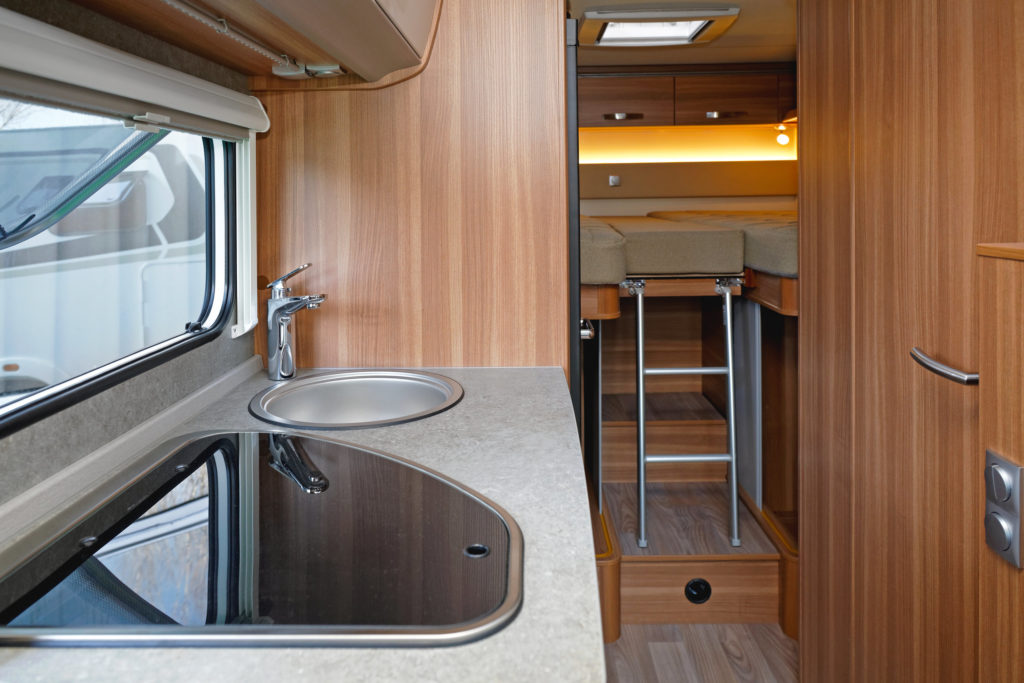 Kitchen and bedroom in camping van